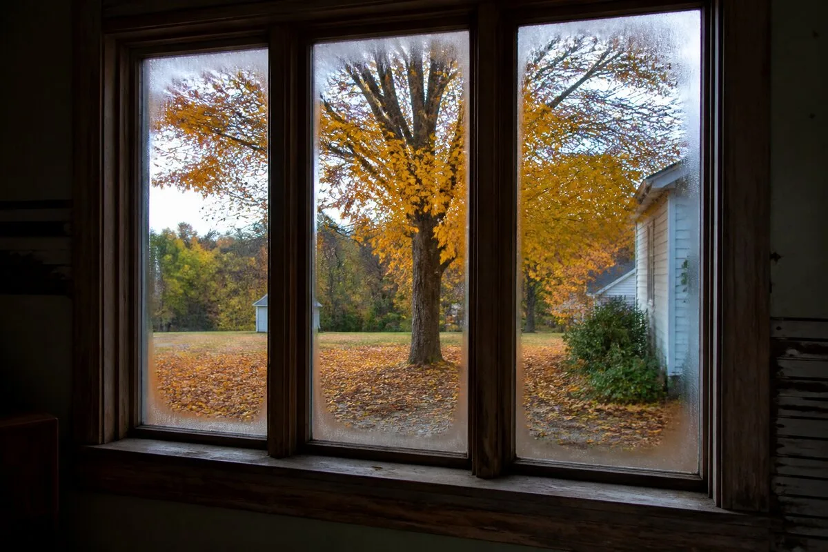 Cold draft near old window in autumn